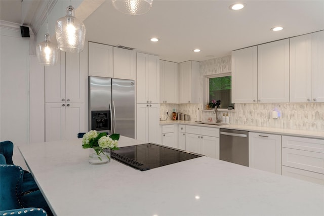 7449 Tophill Ln, Dallas, TX 75248 - kitchen featuring stainless steel appliances, a sink, recessed lighting, white cabinets, and backsplash