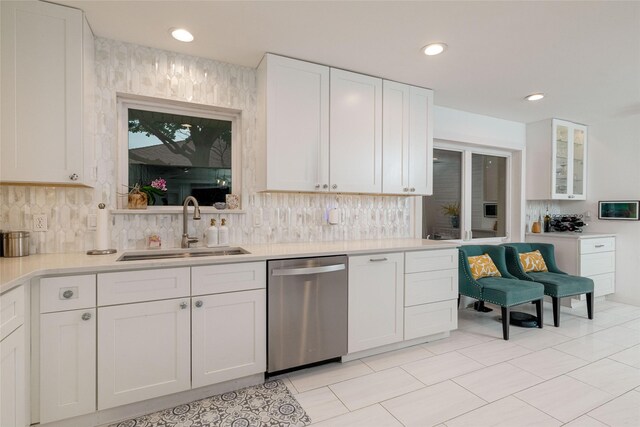 7449 Tophill Ln, Dallas, TX 75248 - kitchen featuring stainless steel dishwasher, a sink, white cabinets, backsplash, and recessed lighting