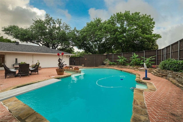 7449 Tophill Ln, Dallas, TX 75248 - view of swimming pool with a diving board, a fenced backyard, and a patio area