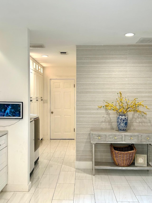 7449 Tophill Ln, Dallas, TX 75248 - hallway with wallpapered walls, an accent wall, and recessed lighting