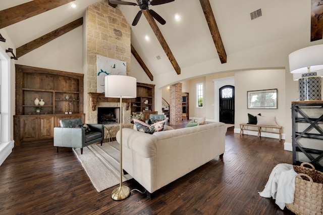 7101 Royal Birkdale Dr, Cleburne, TX 76033 - living area with arched walkways, wood finished floors, beam ceiling, high vaulted ceiling, and a fireplace