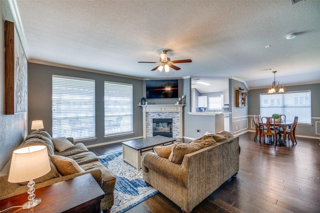 4604 Valleyview Dr, Mansfield, TX 76063 - living room with a textured ceiling, ceiling fan, ornamental molding, healthy amount of natural light, and a fireplace