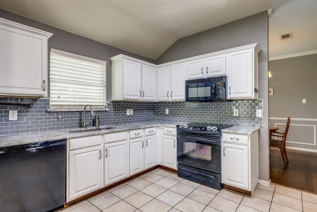 4604 Valleyview Dr, Mansfield, TX 76063 - kitchen with black appliances, a sink, white cabinetry, tasteful backsplash, and vaulted ceiling