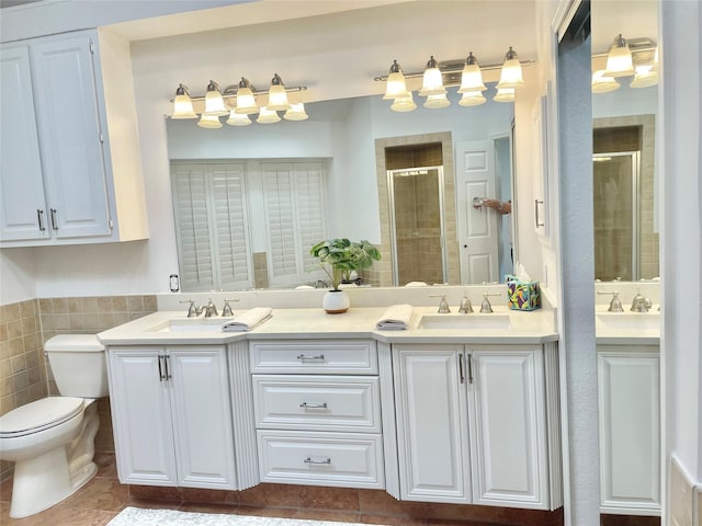 full bathroom featuring double vanity, a shower stall, and a sink