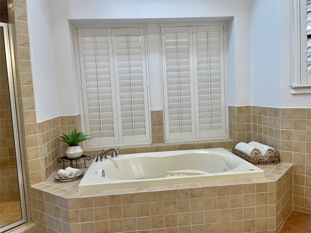 bathroom with a garden tub and a stall shower