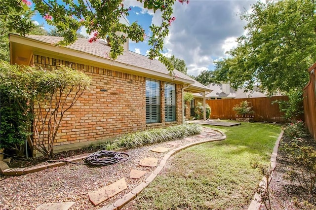 view of yard with a fenced backyard and a patio area