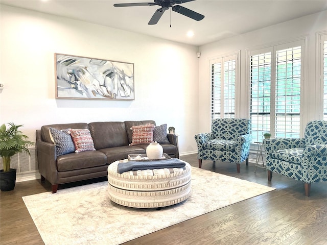 living room with baseboards, ceiling fan, recessed lighting, and wood finished floors