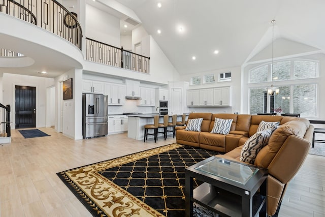1520 Rough Rider Ct, Celina, TX 75009 - living room featuring a chandelier, high vaulted ceiling, visible vents, and stairway