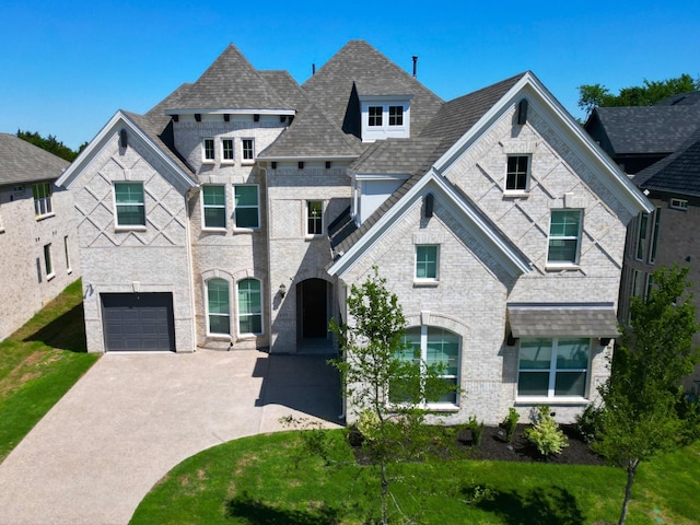 1520 Rough Rider Ct, Celina, TX 75009 - french country style house featuring concrete driveway, an attached garage, and stone siding