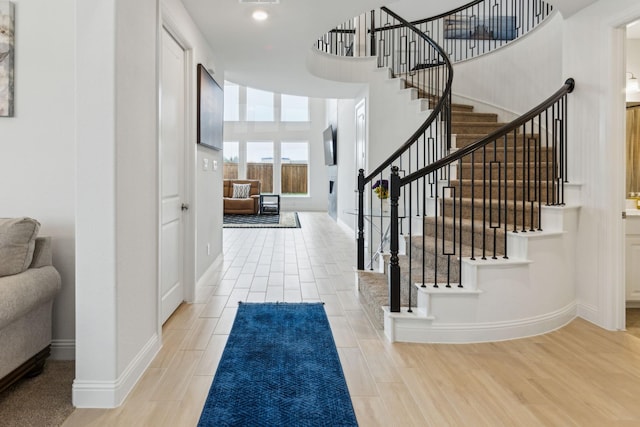 1520 Rough Rider Ct, Celina, TX 75009 - foyer entrance with baseboards, stairs, wood finished floors, and a towering ceiling