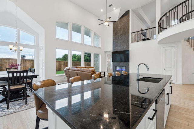1520 Rough Rider Ct, Celina, TX 75009 - kitchen featuring a sink, a spacious island, high vaulted ceiling, and visible vents