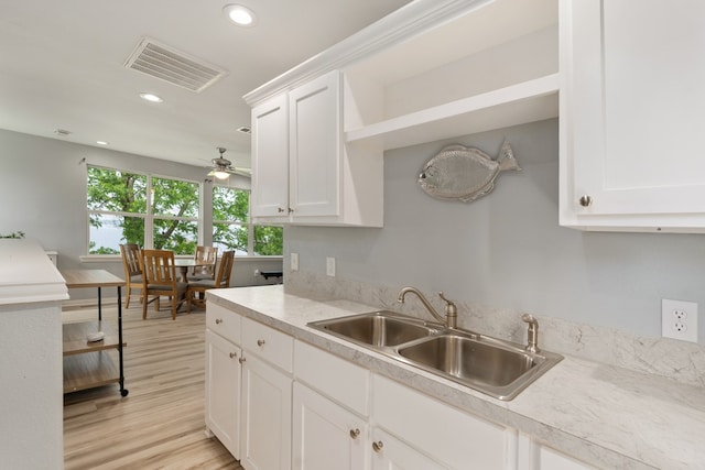 kitchen featuring a sink, light countertops, recessed lighting, and visible vents