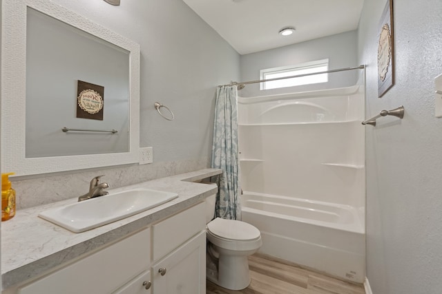 full bathroom featuring vanity, toilet, wood finished floors, and shower / tub combo