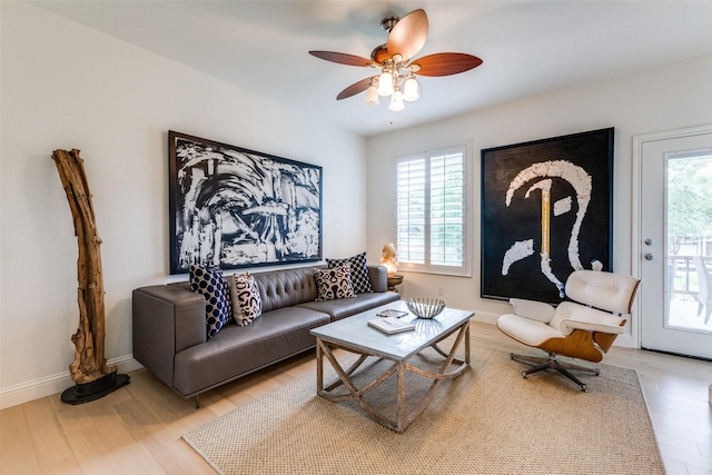 living area with ceiling fan and light wood finished floors