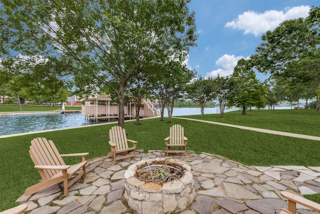 view of patio with a water view and a fire pit