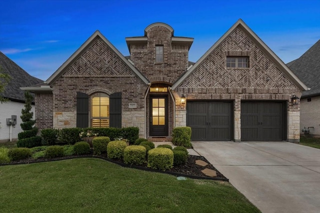 2422 Amesbury Dr, Midlothian, TX 76065 - french country style house with driveway, brick siding, a front yard, a garage, and stone siding