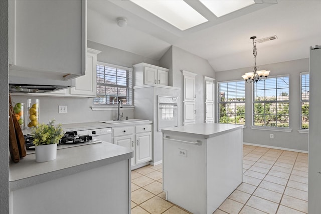 61 Sonora Dr, Trophy Club, TX 76262 - kitchen with an inviting chandelier, oven, light countertops, a sink, and light tile patterned floors