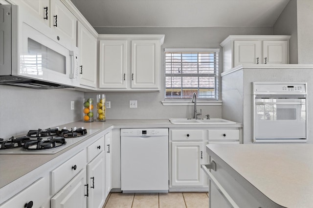 61 Sonora Dr, Trophy Club, TX 76262 - kitchen with white appliances, white cabinets, a sink, and light countertops