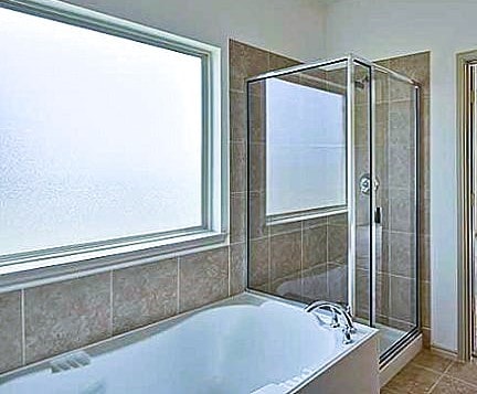 bathroom with tile patterned floors, a stall shower, and a bath