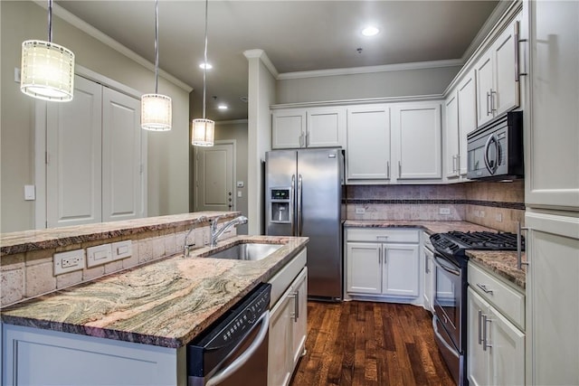kitchen with light stone countertops, a sink, stainless steel appliances, decorative backsplash, and ornamental molding