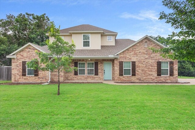 4007 Green Point Dr, Waco, TX 76710 - traditional home with a shingled roof, a front lawn, and brick siding
