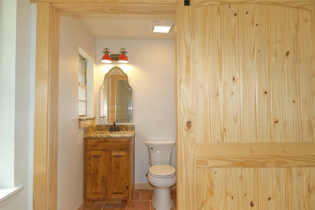 1112 Hillside Dr, Gainesville, TX 76240 - bathroom featuring vanity, tile patterned flooring, and toilet