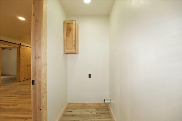 1112 Hillside Dr, Gainesville, TX 76240 - washroom featuring laundry area, light wood-style floors, recessed lighting, electric dryer hookup, and baseboards