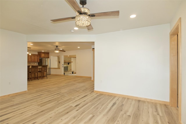 1112 Hillside Dr, Gainesville, TX 76240 - unfurnished living room with recessed lighting, light wood finished floors, ceiling fan, and baseboards