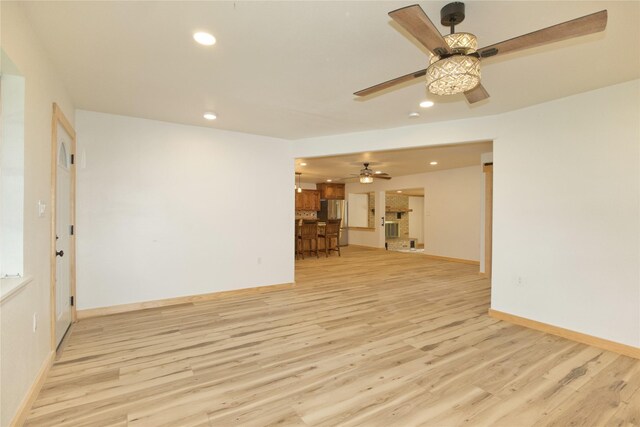 1112 Hillside Dr, Gainesville, TX 76240 - unfurnished living room featuring recessed lighting, light wood-style flooring, ceiling fan, and baseboards