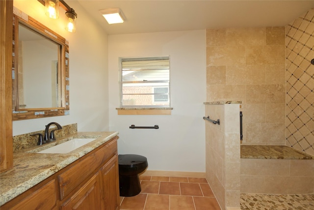 1112 Hillside Dr, Gainesville, TX 76240 - full bath with vanity, tile patterned flooring, toilet, baseboards, and a walk in shower