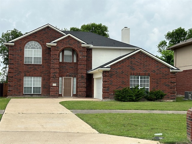 2129 San Simeon Dr, Mesquite, TX 75181 - traditional-style home with a front lawn, brick siding, a garage, a chimney, and driveway
