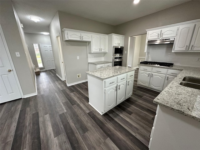 2129 San Simeon Dr, Mesquite, TX 75181 - kitchen with a center island, stainless steel appliances, white cabinetry, and under cabinet range hood