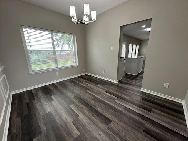 2129 San Simeon Dr, Mesquite, TX 75181 - unfurnished dining area featuring baseboards, a notable chandelier, and dark wood-type flooring