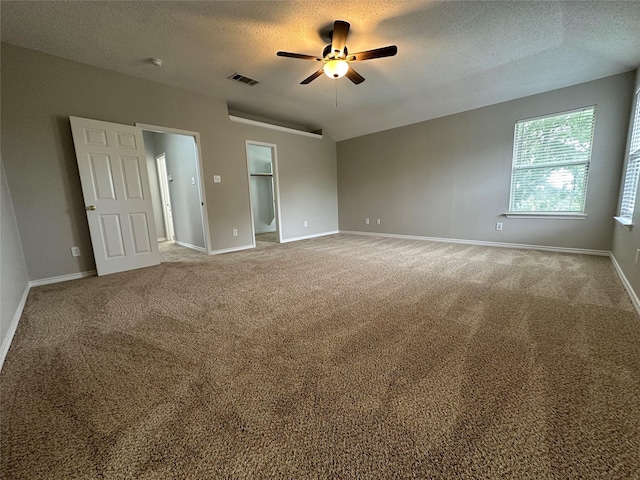 2129 San Simeon Dr, Mesquite, TX 75181 - empty room featuring visible vents, carpet floors, baseboards, a textured ceiling, and a ceiling fan
