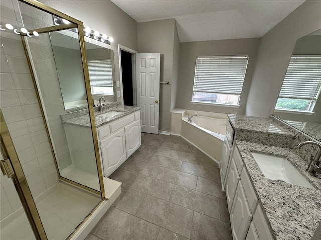 2129 San Simeon Dr, Mesquite, TX 75181 - bathroom with two vanities, a shower stall, a sink, and a garden tub