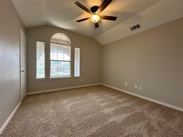 2129 San Simeon Dr, Mesquite, TX 75181 - carpeted empty room with a ceiling fan, lofted ceiling, a textured ceiling, and visible vents