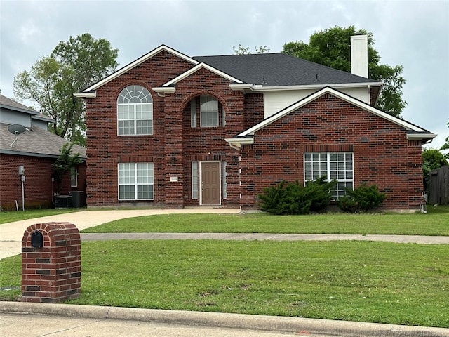 2129 San Simeon Dr, Mesquite, TX 75181 - traditional-style home with brick siding, a front lawn, central AC, and a chimney