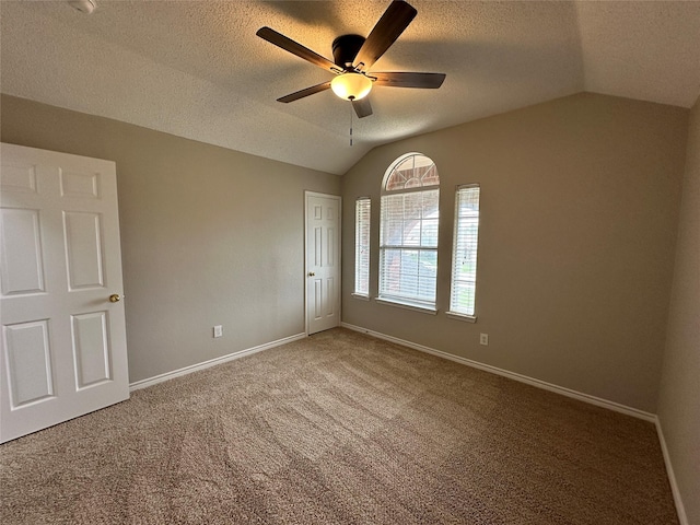 2129 San Simeon Dr, Mesquite, TX 75181 - carpeted empty room featuring baseboards, a ceiling fan, a textured ceiling, and vaulted ceiling