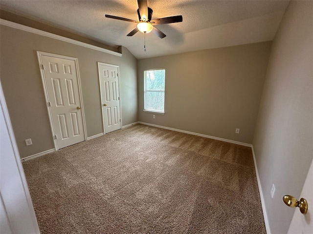 2129 San Simeon Dr, Mesquite, TX 75181 - unfurnished bedroom with baseboards, carpet flooring, a textured ceiling, and lofted ceiling