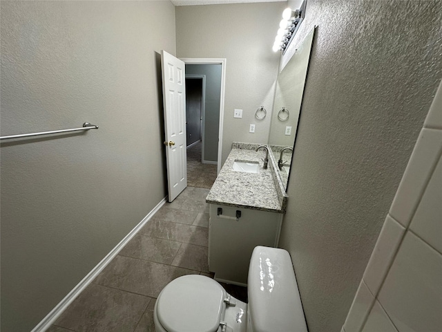 2129 San Simeon Dr, Mesquite, TX 75181 - bathroom featuring tile patterned floors, baseboards, vanity, toilet, and a textured wall