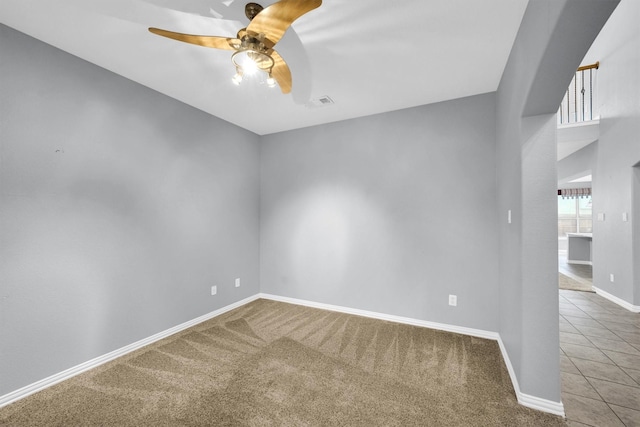 unfurnished room with baseboards, carpet, ceiling fan, and visible vents