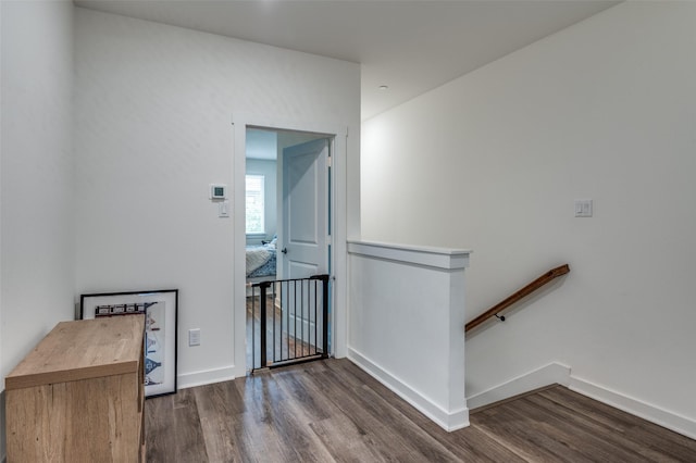 interior space with baseboards and wood finished floors