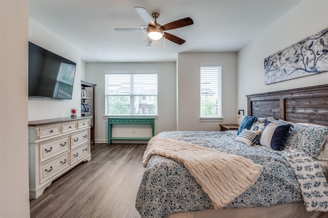 bedroom featuring baseboards, ceiling fan, and wood finished floors