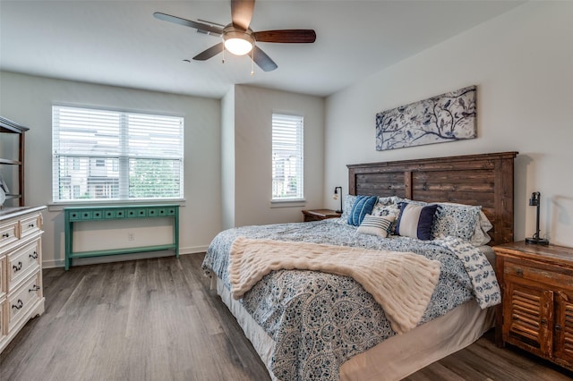 bedroom featuring baseboards, a ceiling fan, and wood finished floors