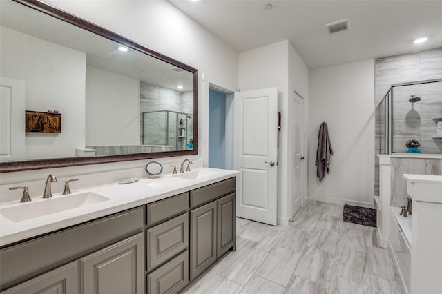 bathroom featuring recessed lighting, visible vents, a sink, and a stall shower