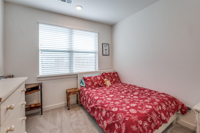 bedroom with baseboards, carpet, and visible vents