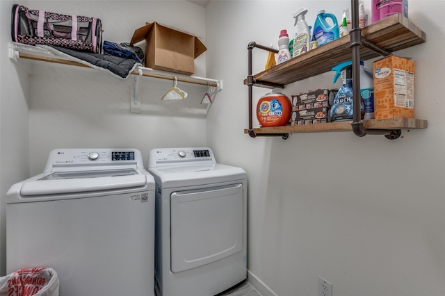 laundry area featuring separate washer and dryer, laundry area, and baseboards