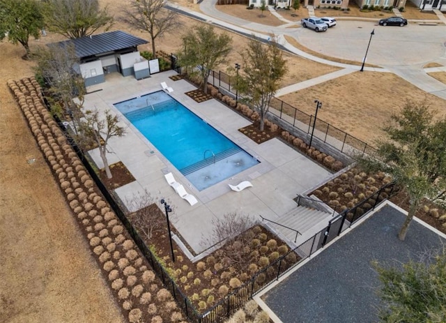 community pool featuring fence and a patio