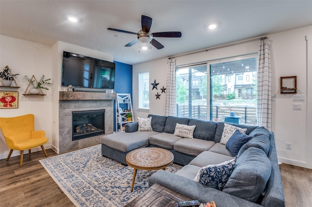 living area with ceiling fan, recessed lighting, wood finished floors, and a tile fireplace