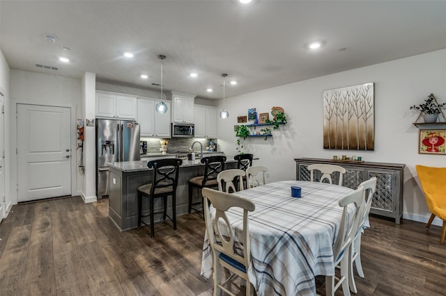 dining area with dark wood finished floors, recessed lighting, and visible vents